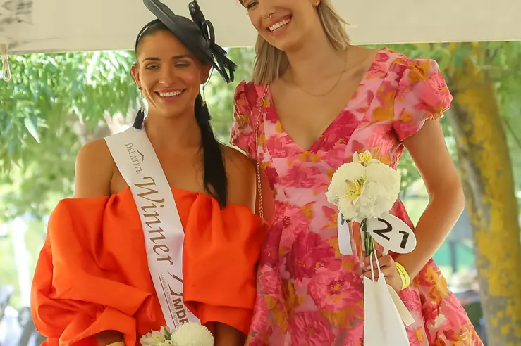 HERE\\'S CHEERS: It was smiles and cheers all round for Lisa Sullivan (left, winner) and Louy Drysdale being judged in the Lady of the Day category at the 2022 Merton Cup race day fashions. Id:34770