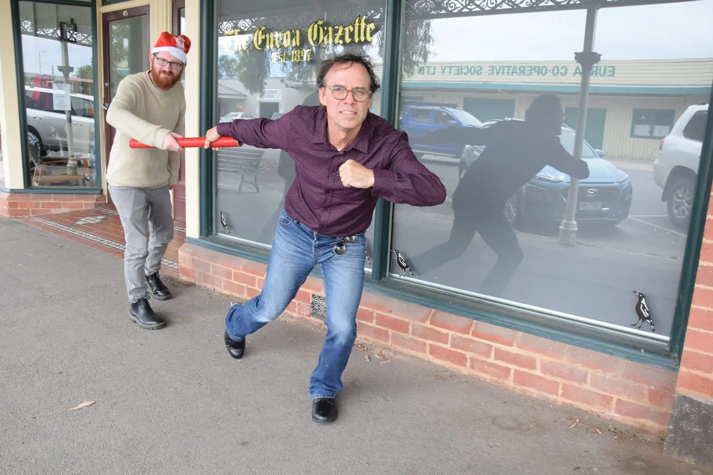 HANDOVER: A Christmas-themed Darren Chaitman (left) handed the baton to Andy Wilson on Monday, ahead of Andy\\'s official start in January 2025.