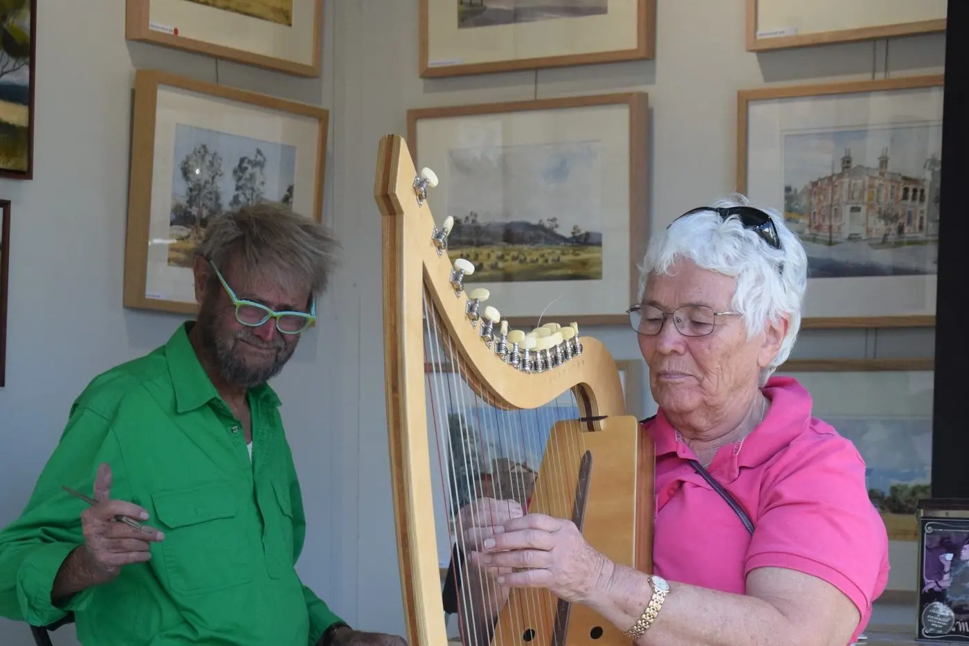 RELAXING AFTERNOON: Di Mackrell playing in Euroa\\'s ARTBOX as Bruce Hargrave potters away at a watercolour. PHOTOS: Andy Wilson
