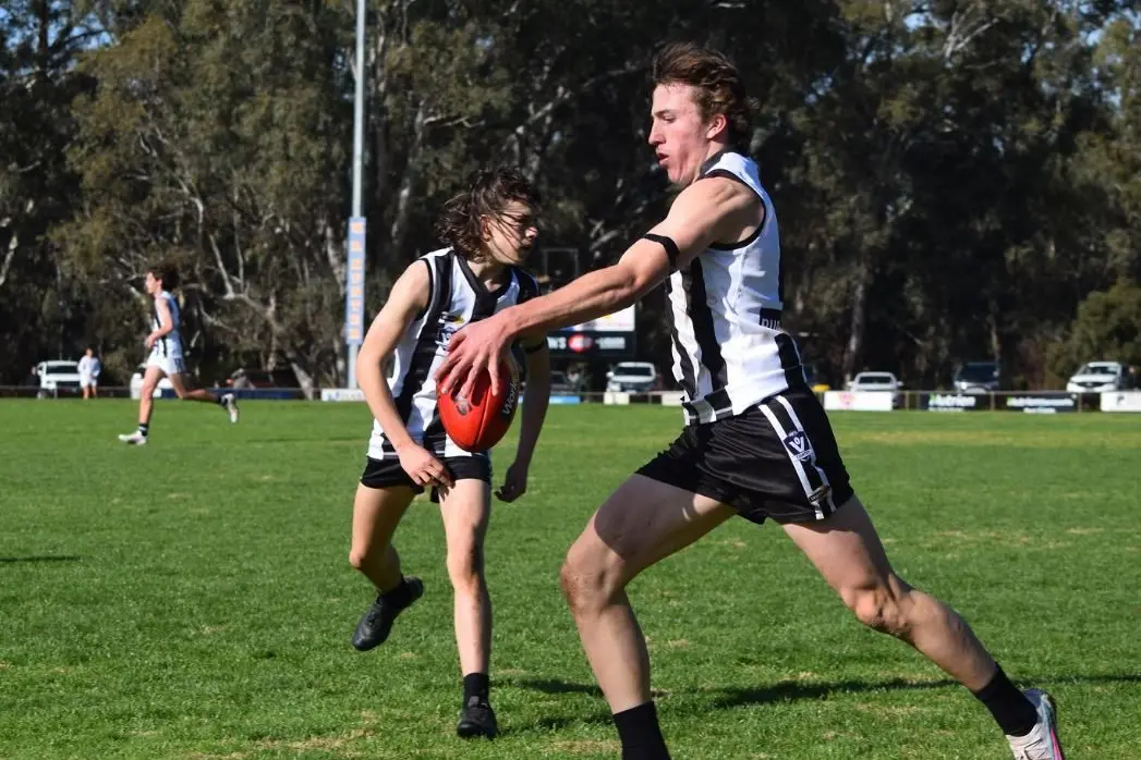 BROTHERLY LOVE: Mitch Walters kicks the ball whilst brother Jack prepares to sheppard. Photo\\u2018s RAELEE JAGER 