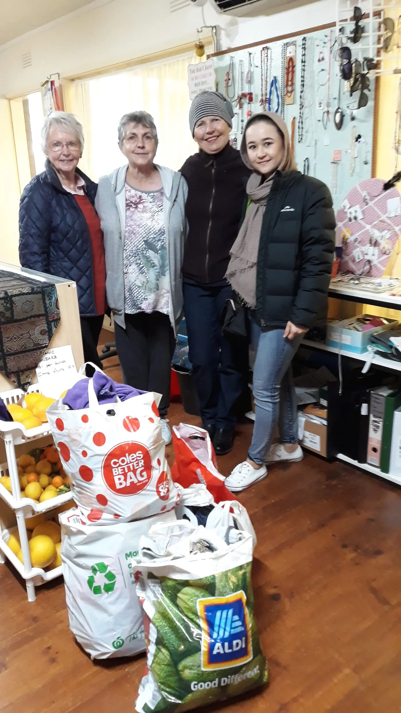 The Violet Town Op Shop has contributed to an initiative organised by Bushra Samadi, who plans to donate several kilograms of clothing to displaced Afghan residents in Pakistan. Pictured: Audra Kunclunas, Cheryl Taylor and Elaine Hayes with Bushra Samadi (right). PHOTO: Ruth Fluhr Id:28963