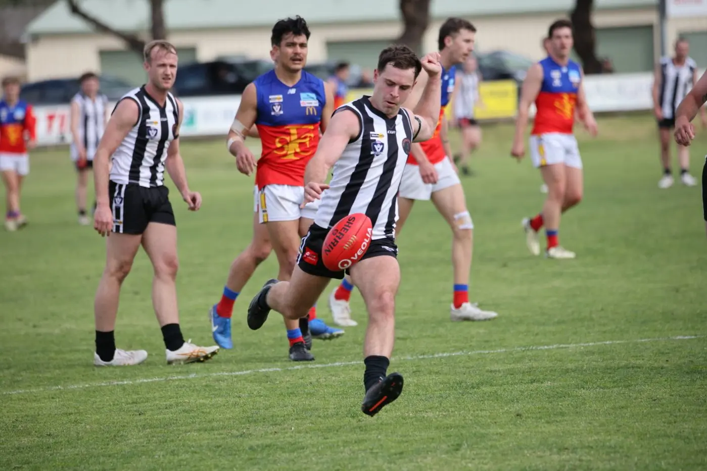 BOOT TO THE BALL: Max Gleeson set to kick; JD Hayes, at the back, looks on. PHOTOS: Matthew Mills