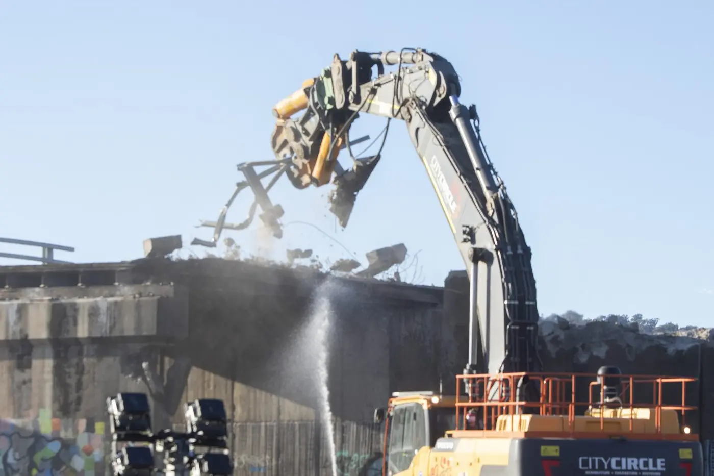 CHOMPING DOWN: A crane excavator begins removing guard railings on Monday afternoon. PHOTOS: Dale Mann