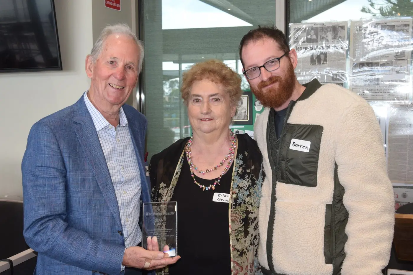 22 YEARS WITH THE GAZETTE: At her retirement celebration, North East Media managing director Hartley Higgins (left) presented Di Grant with a plaque recognising her 22-year contribution to this masthead. Also present was Euroa Gazette journalist Darren Chaitman (right). PHOTO: John Grant