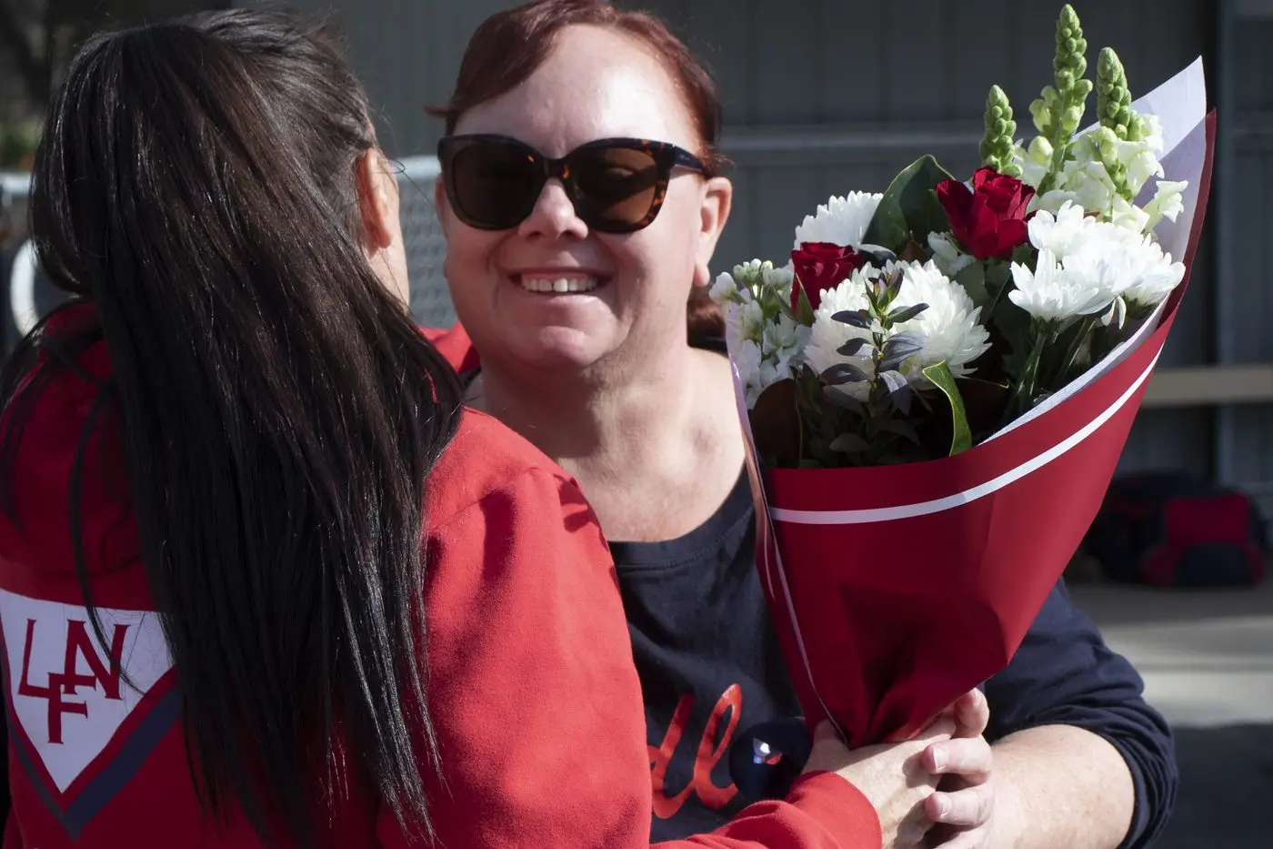 SWEET CELEBRATION: Carley Murphy is presented with flowers for her 250 game-strong commitment to Longwood netball both on and off the court. PHOTO: Dale Mann
