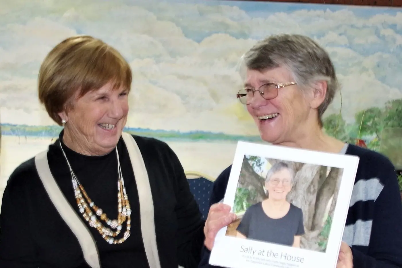 FAREWELL: Nagambie Lakes Community House president Edna James (left) said \"au revoir\" to Sally Fyfield, presenting her with a photo book of her activities at the house and a painting. PHOTO: Di Grant Id:42222