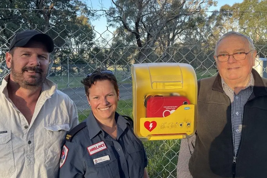 LIFE-SAVING DEVICE: Longwood Action Group president Chris Martin (left), Ambulance Victoria ACO Shona Guest and Longwood East Landcare president Kevin Lied with the new AED.