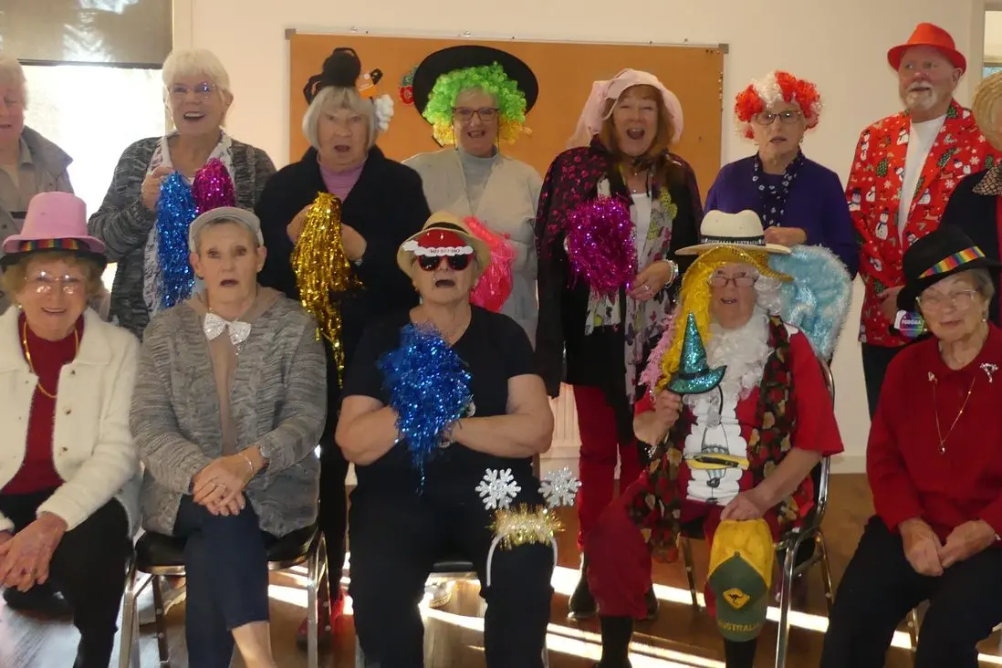MUSICAL DRESS UPS GANG: Back row: Dawn O\\u2019Rourke, Betty Roworth, Jan Fish, Robyn Spinner, Bev Benson, Norma Walton, John Smith (singer), Sue Gray. Front row: Margaret Marks, Sue Parkinson, Marlene Brew, Maureen \\u201CSanta\\u2019s helper\\u201D Fowler, and Monika Guest. PHOTO: Di Grant