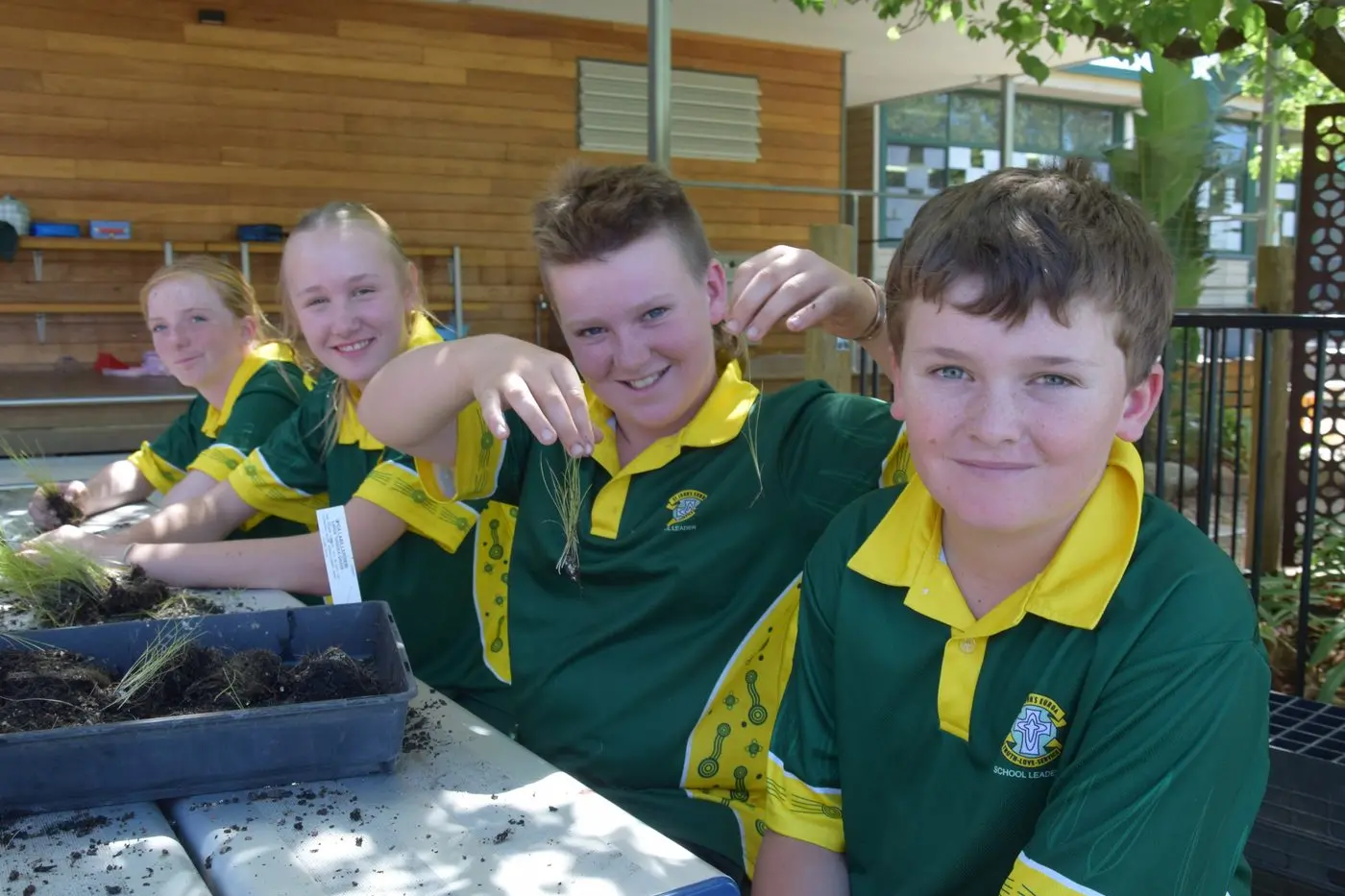 DIVIDE AND GROW: Grace O\\'Dea, Lilly Cakebread, Carter Simmons, and Jim McDermid enjoying an afternoon planting out baby native grasses. PHOTOS: Andy Wilson