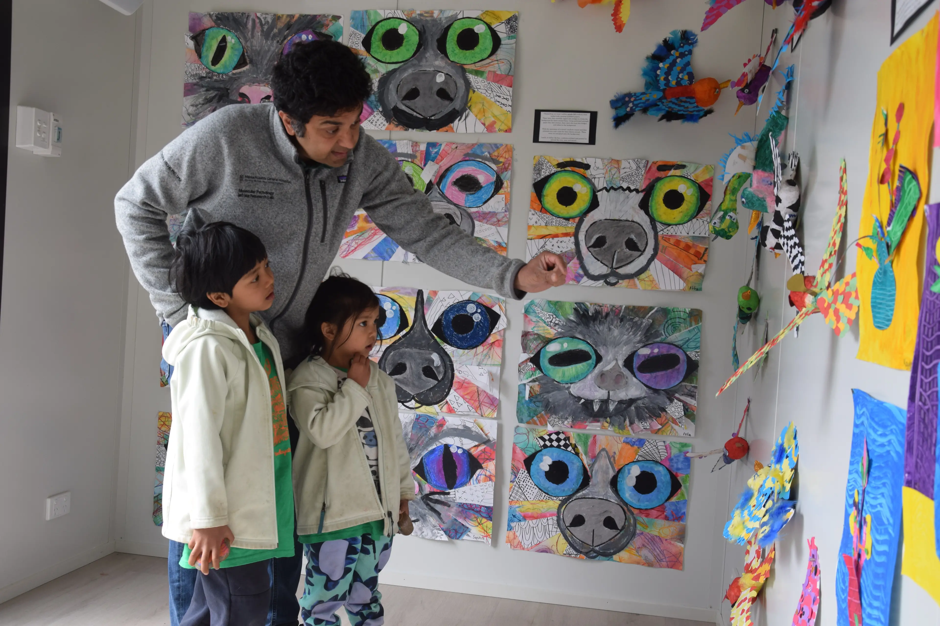 <p>Narayan, 6, and his sister Indira, 4, take in the artwork with their father Vivek.</p>\\n